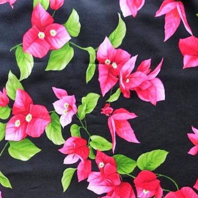 Tissu fibranne noir et fleurs de bougainvilliers roses - Largeur 150 cm